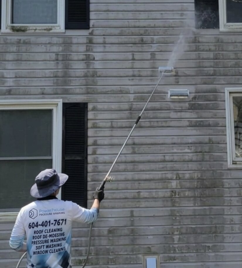 Powerhouse Pressure Washing crew cleaning a townhouse corner in Clearbrook, Abbotsford